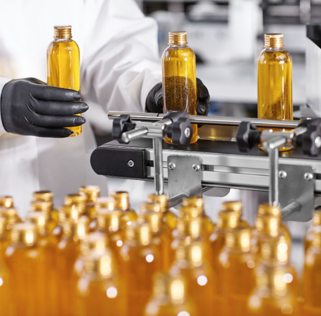 Amber liquid fertiliser bottles on a filling line