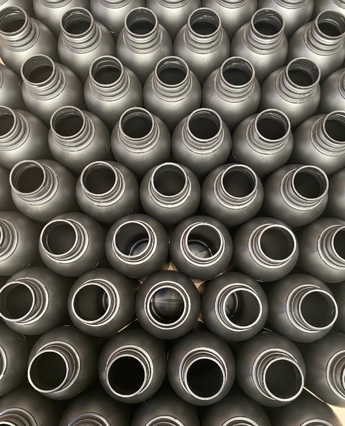 Rows of empty aluminium bottles ready for filling